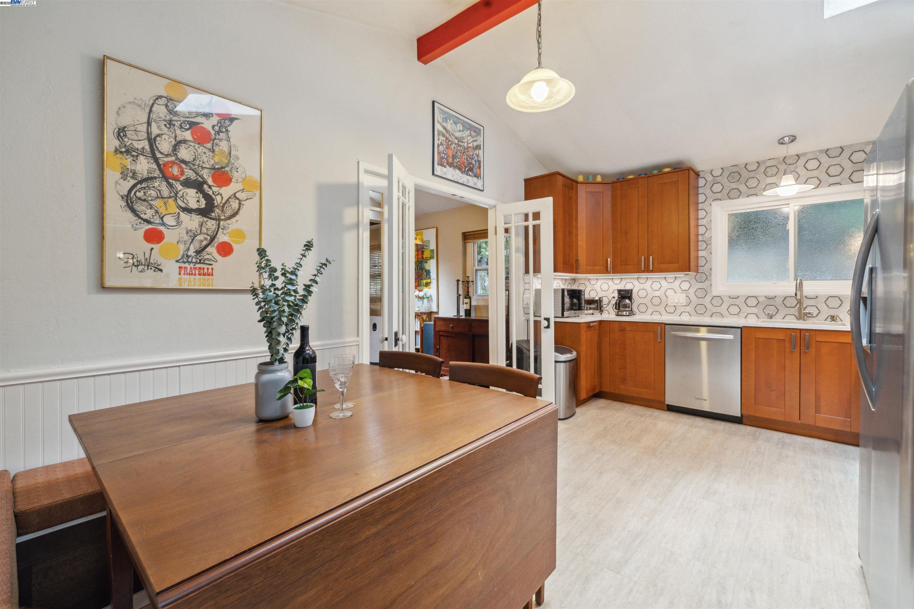 495 Primavera Road Boulder Creek, CA 95006 - Photo 6 of 33 a kitchen with stainless steel appliances granite countertop a sink dishwasher and cabinets with wooden floor