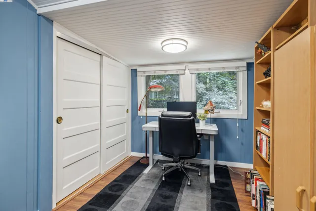 a view of a patio with table and chairs and wooden floor