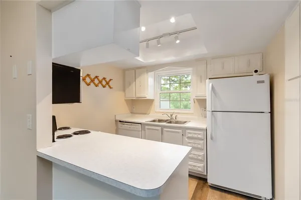 a white refrigerator freezer sitting inside of a kitchen