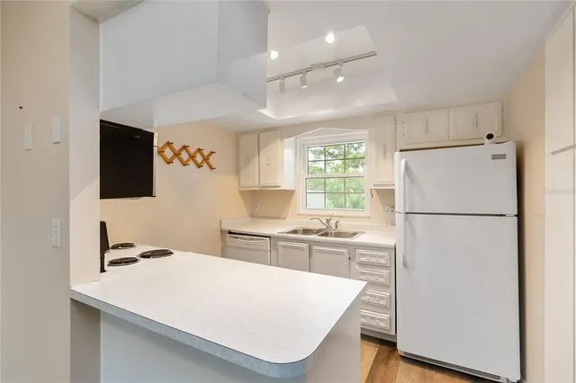 a white refrigerator freezer sitting inside of a kitchen
