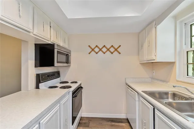 a kitchen with stainless steel appliances a sink a stove and a refrigerator