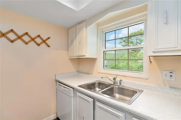 a kitchen with a sink and a window