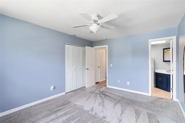 a view of a livingroom with a ceiling fan and window