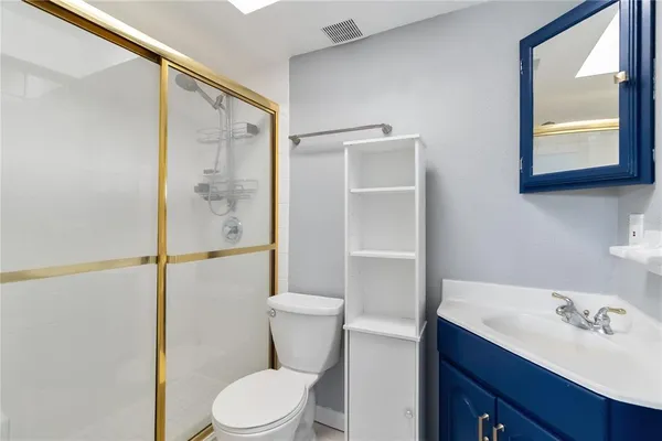 a bathroom with a sink vanity mirror and toilet