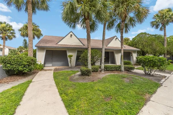 a front view of a house with a garden and patio
