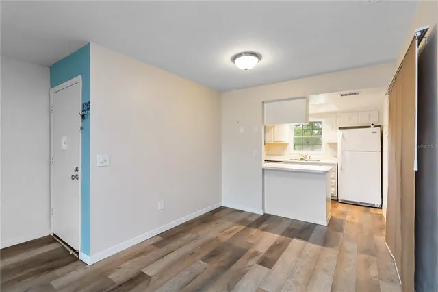 a view of a kitchen with wooden floor and a sink