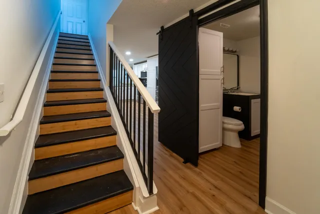 a view of a hallway with wooden floor and entryway