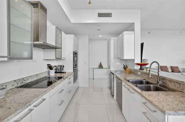 a kitchen with stainless steel appliances granite countertop a sink stove and cabinets