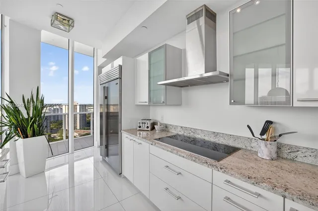 a kitchen with stainless steel appliances granite countertop a sink a stove and cabinets