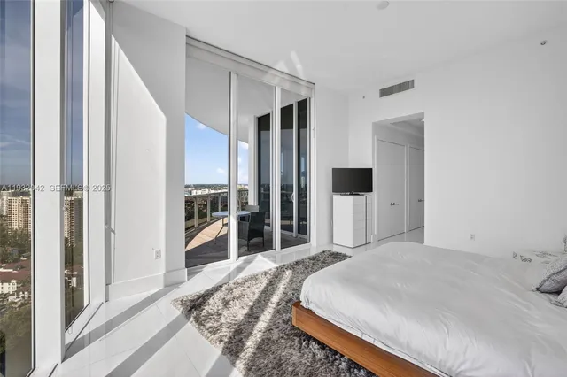 a bedroom with a large bed and walk in closet