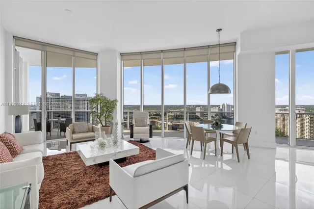 a living room with furniture and large windows