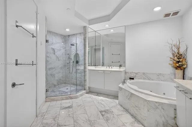 a bathroom with a tub sink and mirror