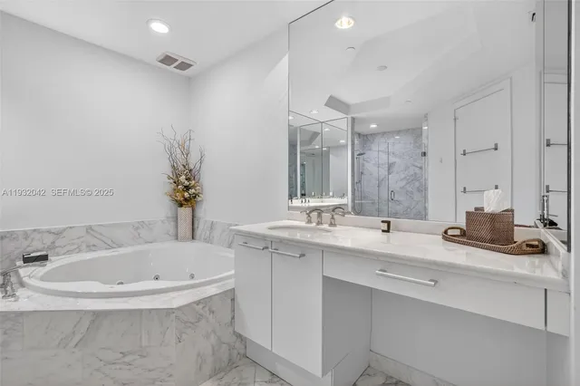 a bathroom with a shower sink and mirror