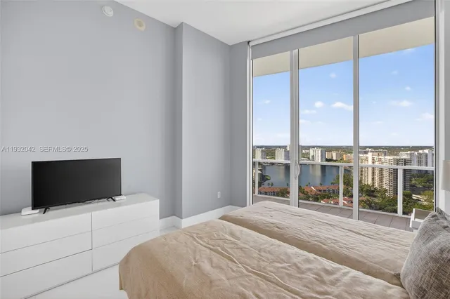 a spacious bedroom with a large bed and a large window