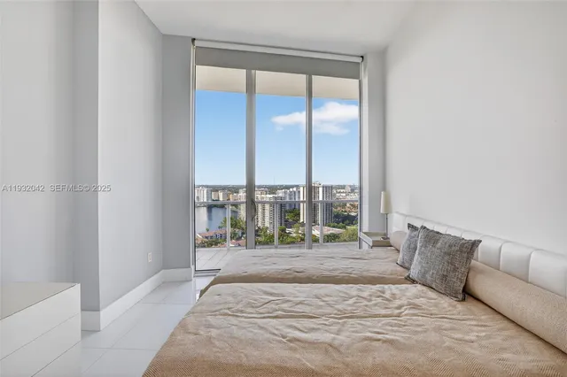 a bedroom with a large window and a bed