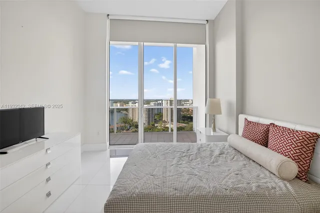 a bedroom with a bed and a flat screen tv