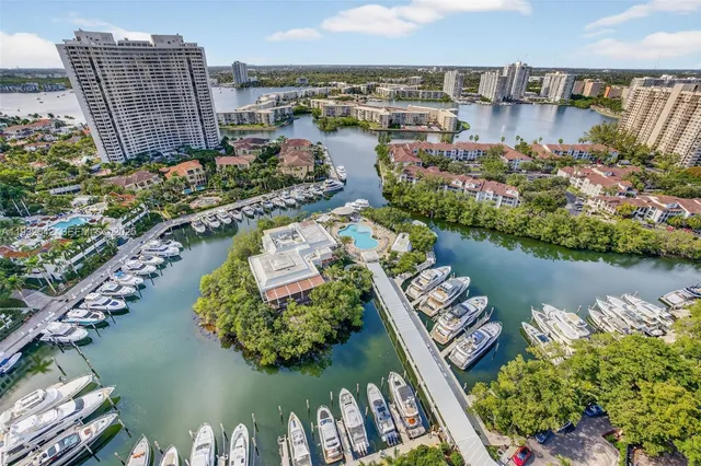 an aerial view of a house with a garden and lake view