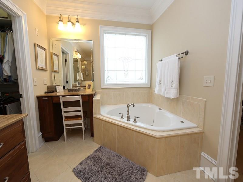1420 Duplin Road Raleigh, NC 27607 - Photo 16 of 25 a bathroom with a bathtub and a sink
