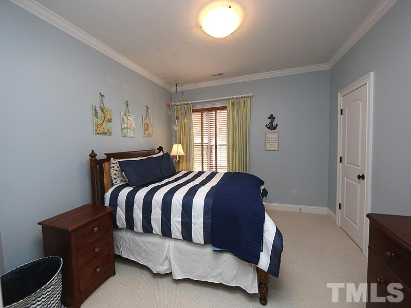 1420 Duplin Road Raleigh, NC 27607 - Photo 20 of 25 a bed sitting in a bedroom next to a window