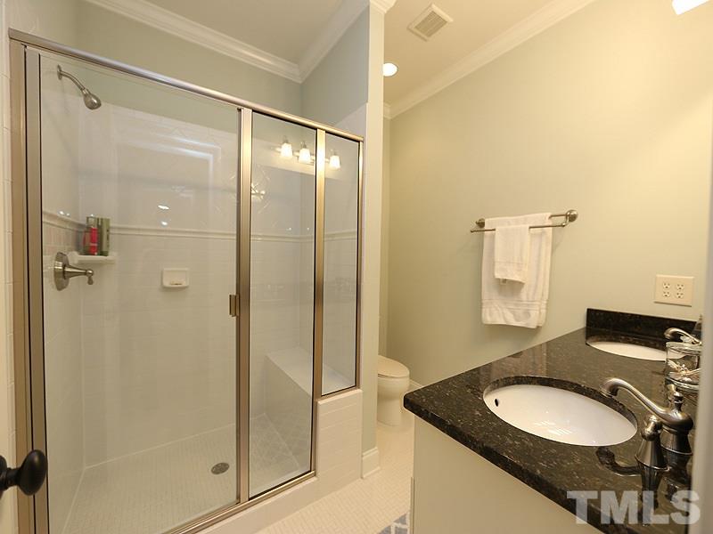 1420 Duplin Road Raleigh, NC 27607 - Photo 21 of 25 a bathroom with a granite countertop sink mirror and a shower