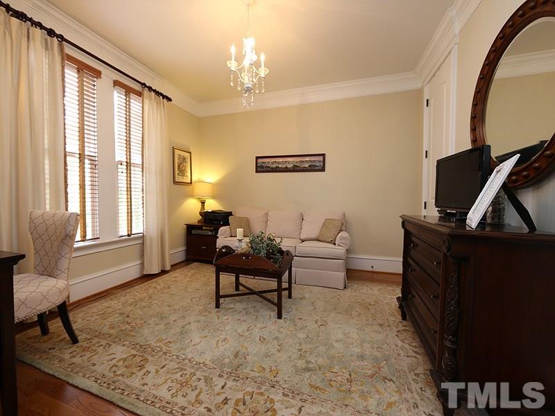 1420 Duplin Road Raleigh, NC 27607 - Photo 5 of 25 a living room with furniture a flat screen tv and a window