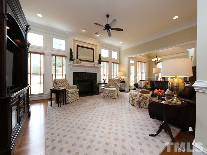 1420 Duplin Road Raleigh, NC 27607 - Photo 8 of 25 a living room with furniture flat screen tv and a fireplace