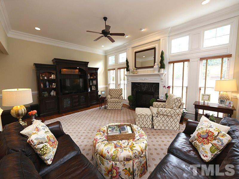 1420 Duplin Road Raleigh, NC 27607 - Photo 9 of 25 a living room with furniture fireplace and a flat screen tv