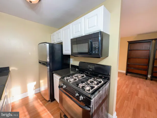 a kitchen with stainless steel appliances a stove a microwave and a refrigerator
