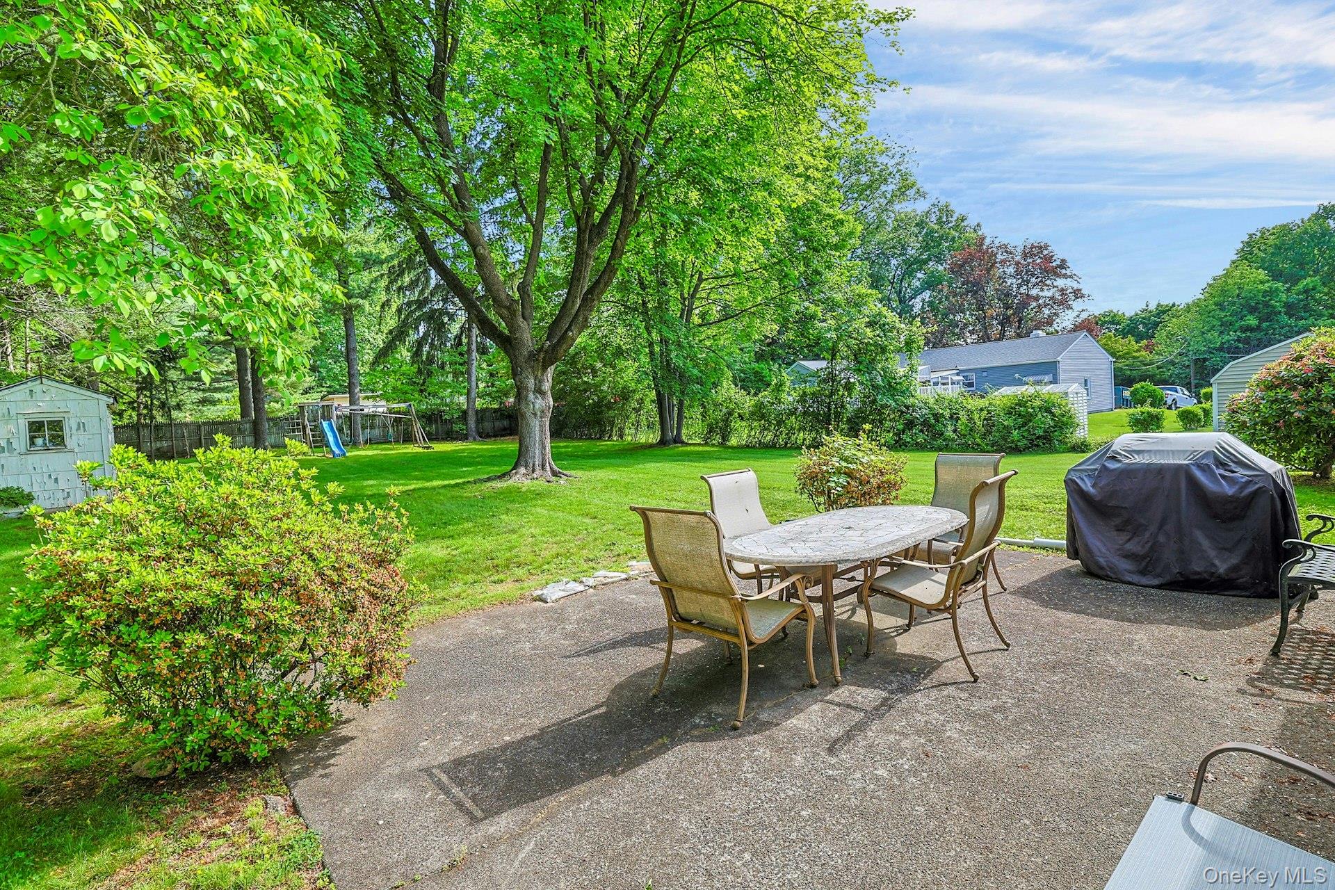 31 Townline Road Pearl River, NY 10965 - Photo 21 of 27 a view of a chairs and table in backyard