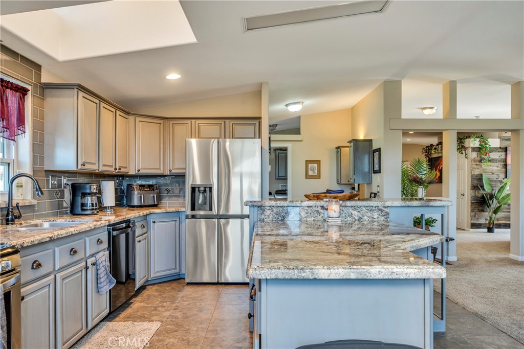 17432 Sendero Way Lower Lake, CA 95457 - Photo 11 of 65 a kitchen with kitchen island granite countertop a sink cabinets and stainless steel appliances