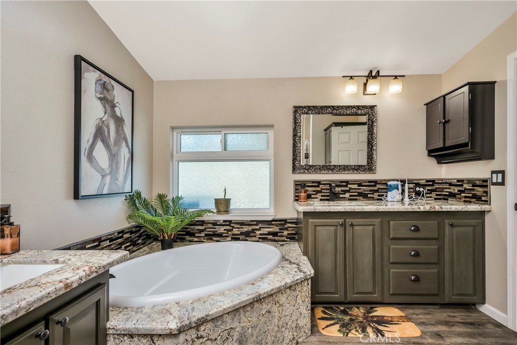 17432 Sendero Way Lower Lake, CA 95457 - Photo 24 of 65 a bathroom with a granite countertop sink and a mirror