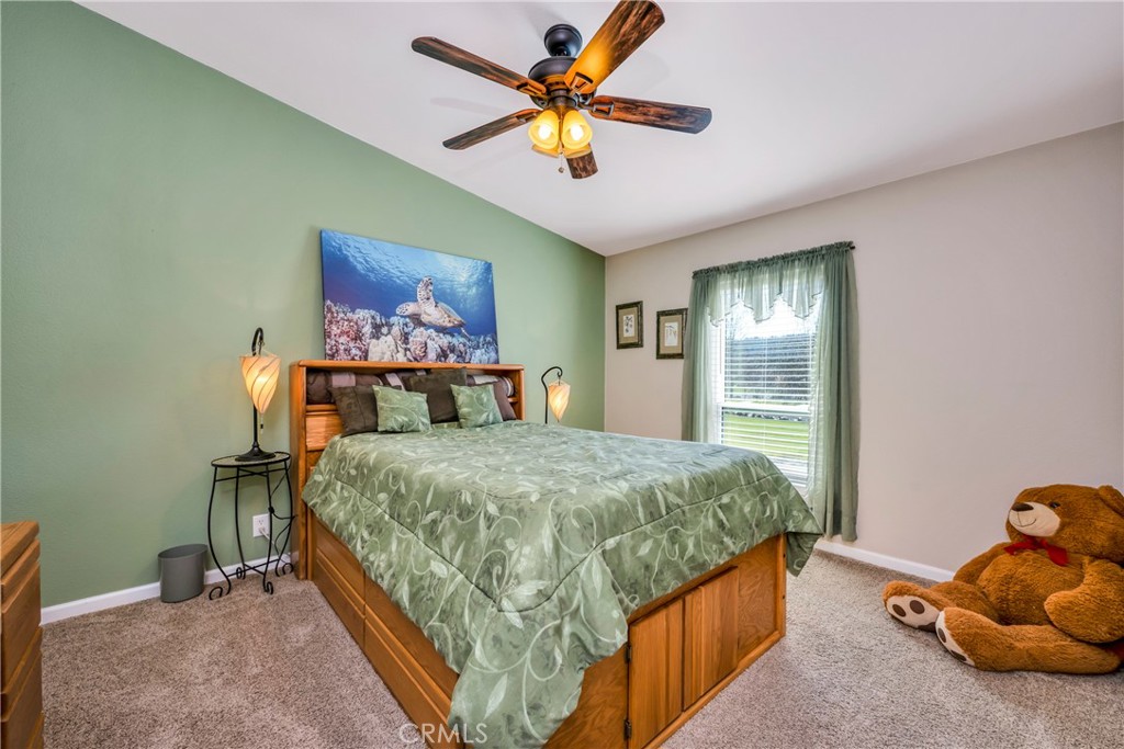 17432 Sendero Way Lower Lake, CA 95457 - Photo 25 of 65 a bedroom with a bed and a chandelier