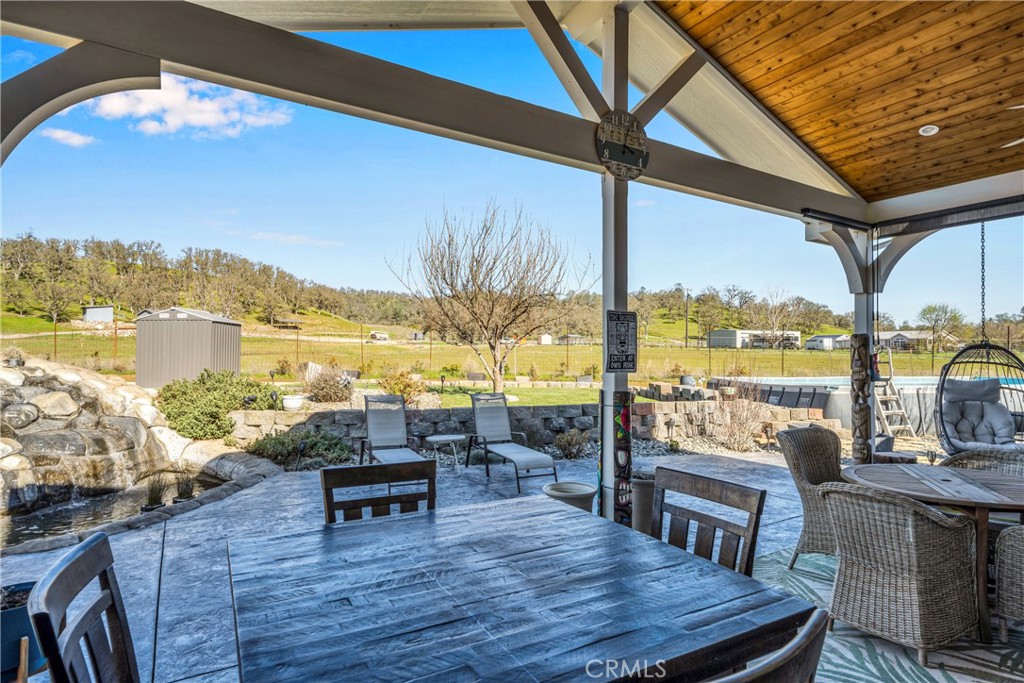 17432 Sendero Way Lower Lake, CA 95457 - Photo 42 of 65 a roof deck with table and chairs a barbeque with wooden floor and fence
