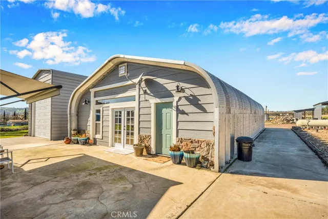 a front view of a house with a yard table and chairs