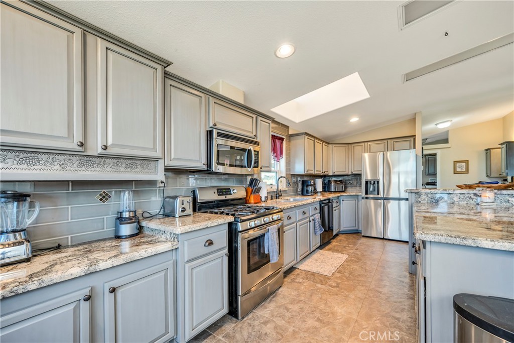 17432 Sendero Way Lower Lake, CA 95457 - Photo 10 of 65 a kitchen with stainless steel appliances granite countertop a stove top oven a sink and dishwasher a oven with white cabinets