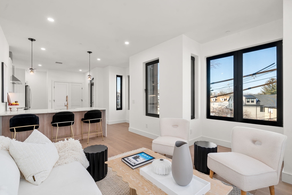 a living room with furniture and large windows