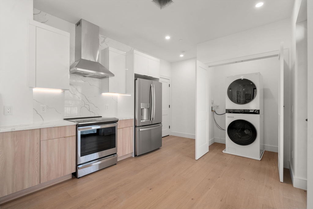 84 Prospect Street, Unit 302 Somerville, MA 02143 - Photo 5 of 9 a view of a kitchen with washer and dryer