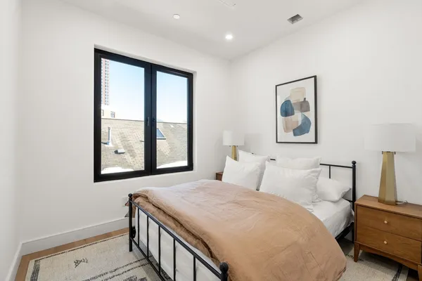 a bedroom with a bed and a window