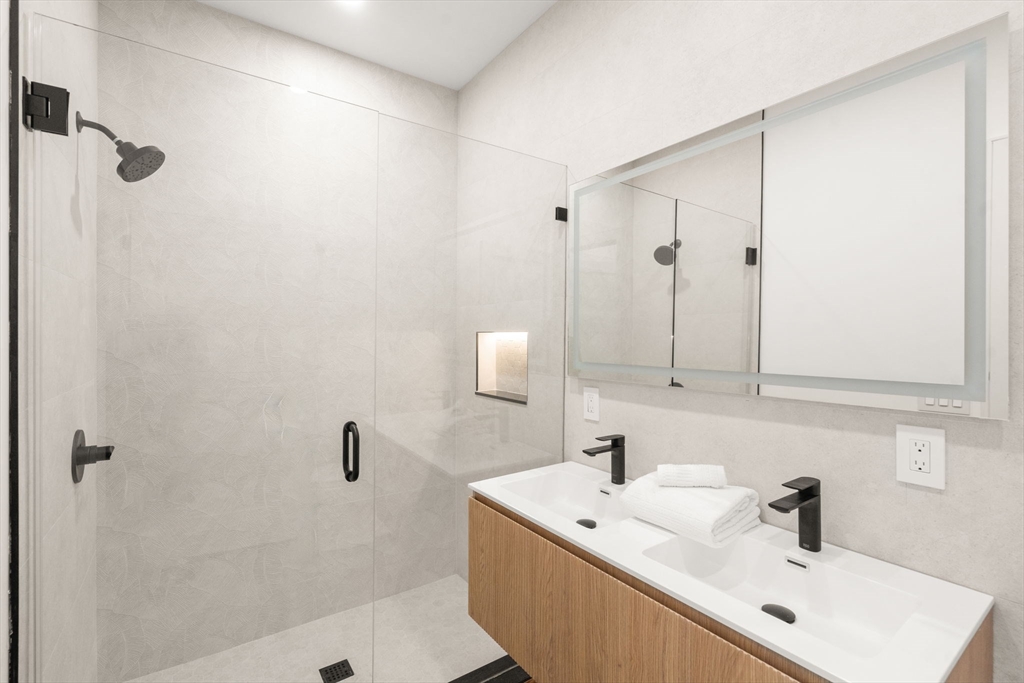 84 Prospect Street, Unit 302 Somerville, MA 02143 - Photo 7 of 9 a bathroom with a sink a shower and mirror