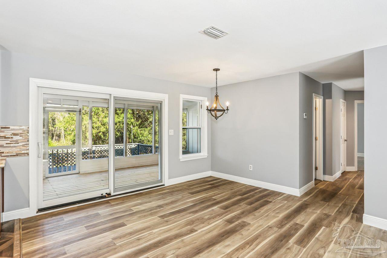 4900 Shell Road Milton, FL 32583 - Photo 10 of 52 a view of empty room with wooden floor and fan