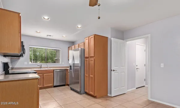 a kitchen with stainless steel appliances a refrigerator and a sink