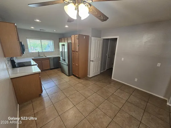 a view of kitchen with furniture and a refrigerator