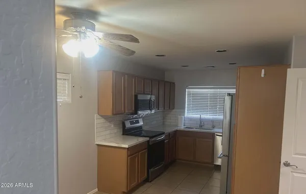 a kitchen with kitchen island a sink stainless steel appliances and cabinets