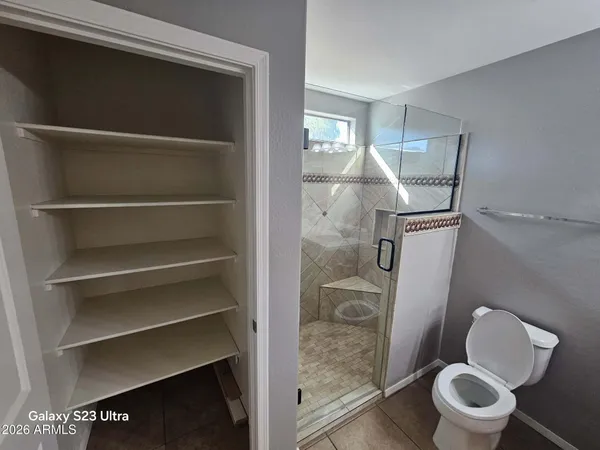 a bathroom with a toilet and a shower