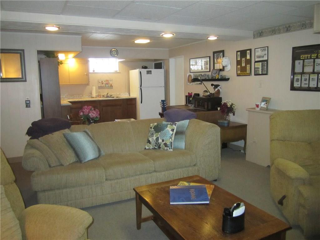 203 Murrysville Road Level Green, PA 15085 - Photo 19 of 24 Great for entertaining. Kitchen makes serving food or drinks easy. Door on right leads to 1 car garage with extra storage/work area and then outside to the carport. Electric service has been updated.