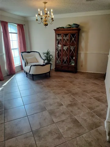 a living room with couches and a chandelier