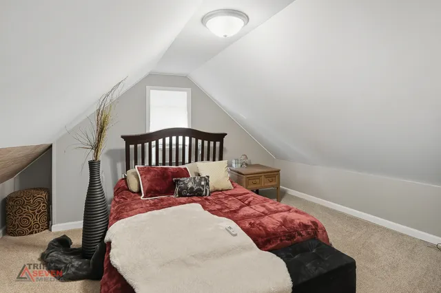 a bedroom with a bed and a chair