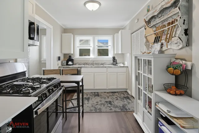 a kitchen with stainless steel appliances granite countertop a stove and a sink