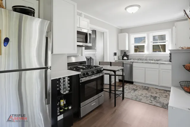 a kitchen with stainless steel appliances a refrigerator stove and sink
