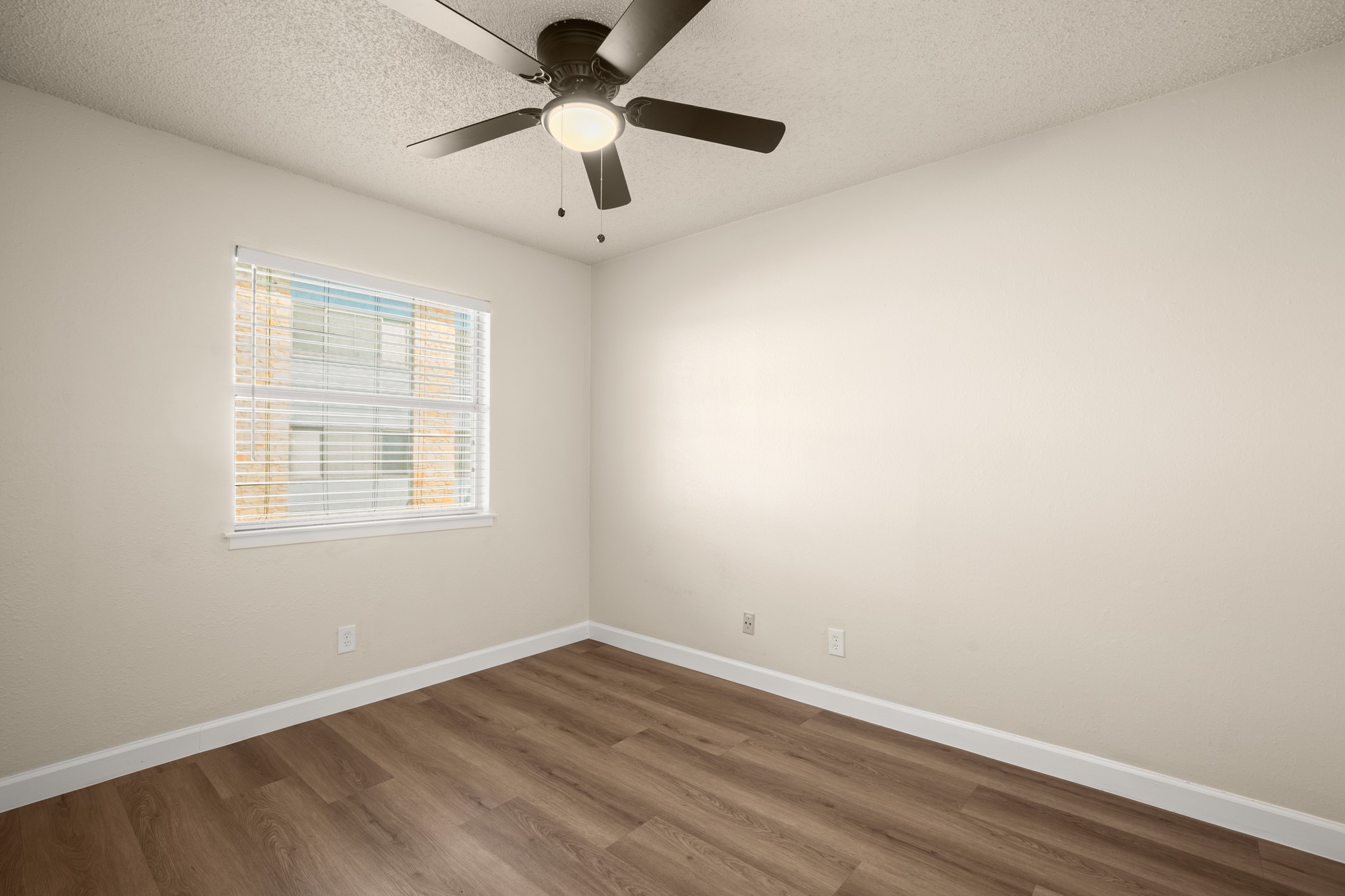2408 Longview Street, Unit 112 Austin, TX 78705 - Photo 11 of 15 an empty room with a window and a fan